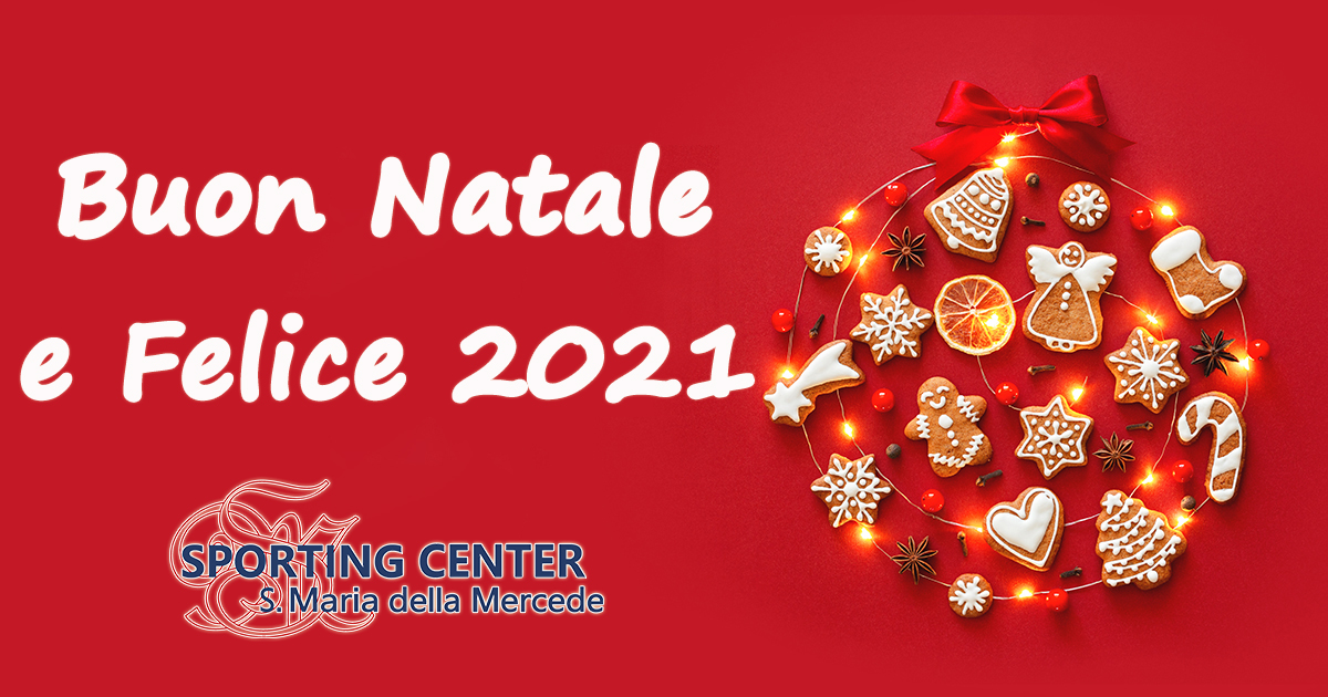 Creative Christmas ball made of iced gingerbread cookies, anise stars, berries, orange chips, decorated red ribbon bow on red background. New Year banner. Top view.